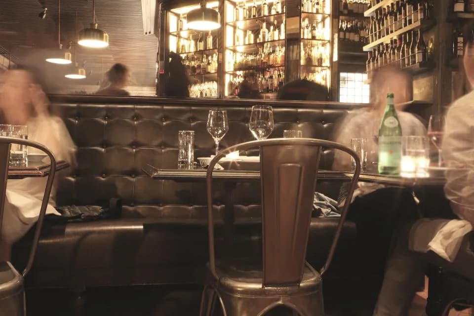 Guests dining at tables in a full-service restaurant